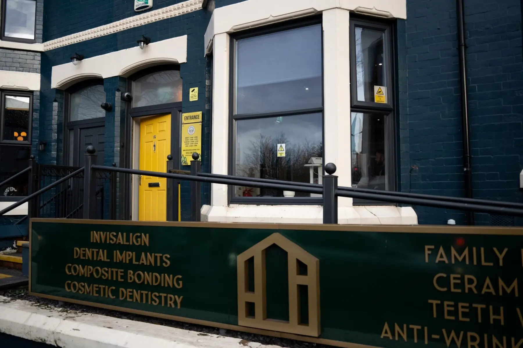The Dental House on Derby Lane, Old Swan, with its yellow front door and green and gold signboard
