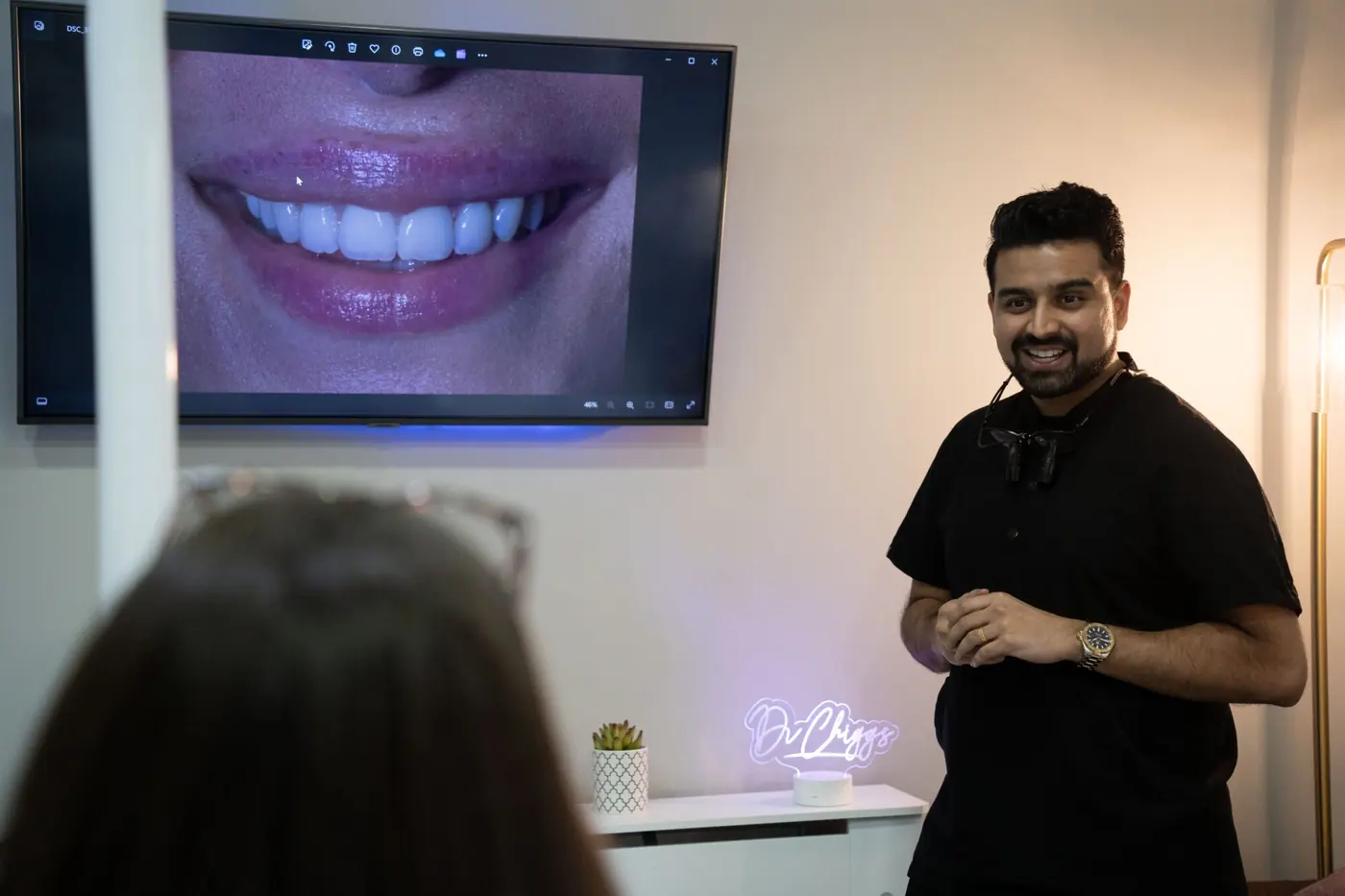 A dentist reviewing a patient's new smile on a screen